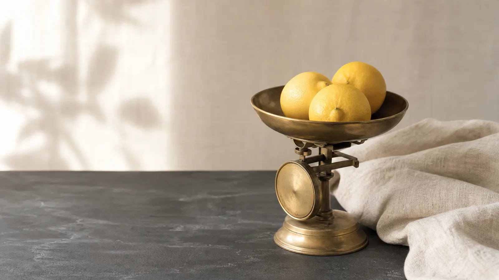 Brass kitchen scales with lemons on slate