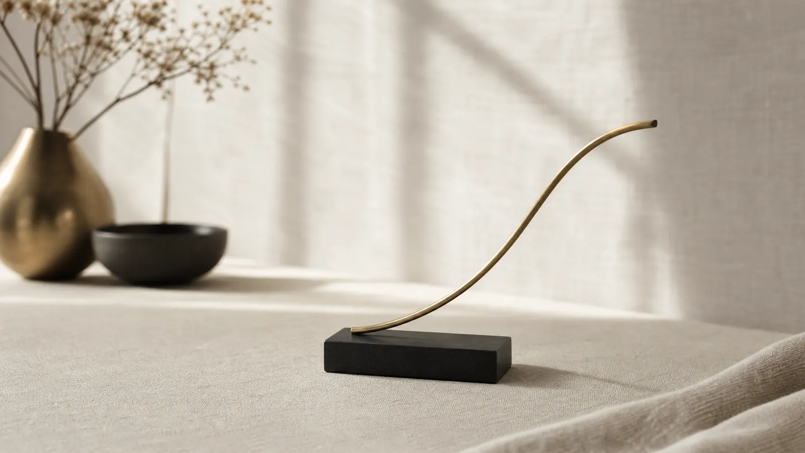 Brass sculpture of a gently rising curve